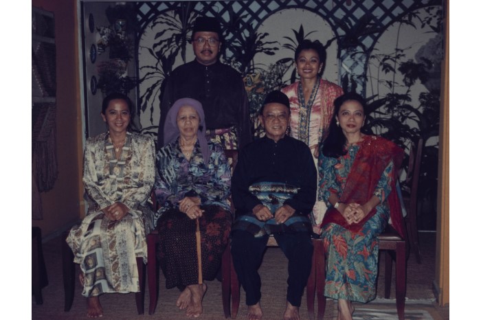 <p style="border: none;"><a href="/assets/cd1ab4ac-de78-4e4f-84b8-304171001780/Fauziah and Faridah Jamal Family Photo.jpg">Fauziah and Faridah Jamal (respectively standing and seated on left) in a family photograph with their late father Haji Ahmad Jamal bin Haji Hassan, their mother Hajjah Fatimah binti Haji Mohd Alie, their sister Faizah and brother Husni during Hari Raya in their house at Bukit Timah</a>